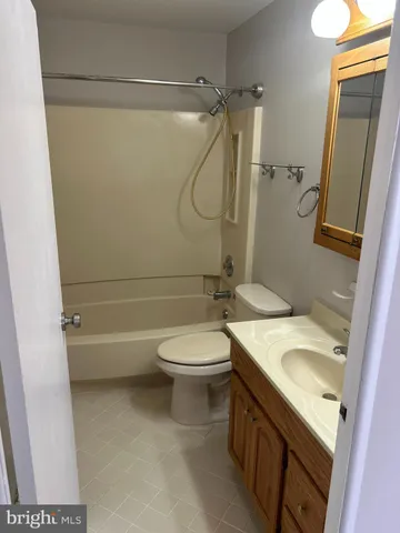 a bathroom with a granite countertop toilet sink and shower