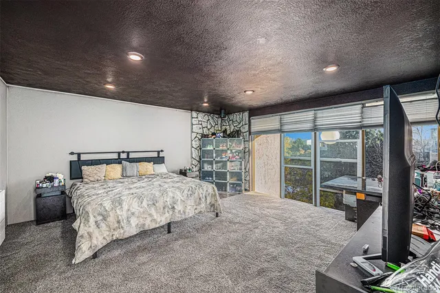 a bedroom with a large bed and a large window