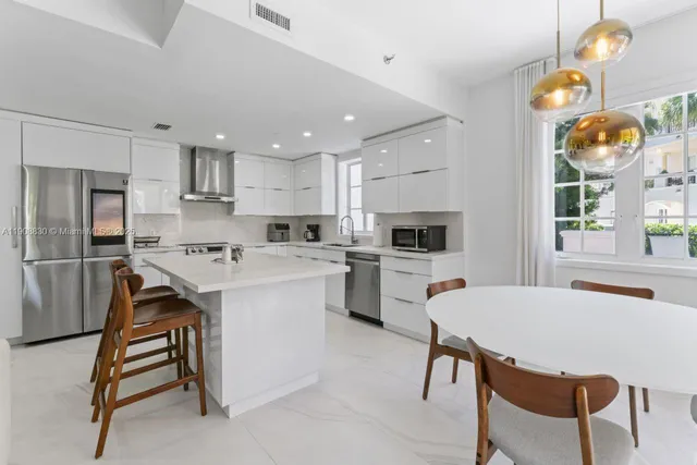 a kitchen with a sink a microwave and refrigerator