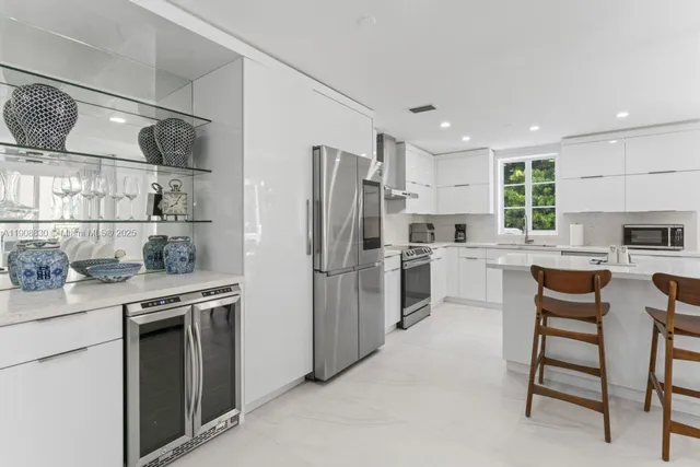 a kitchen with stainless steel appliances a refrigerator sink and wooden cabinets