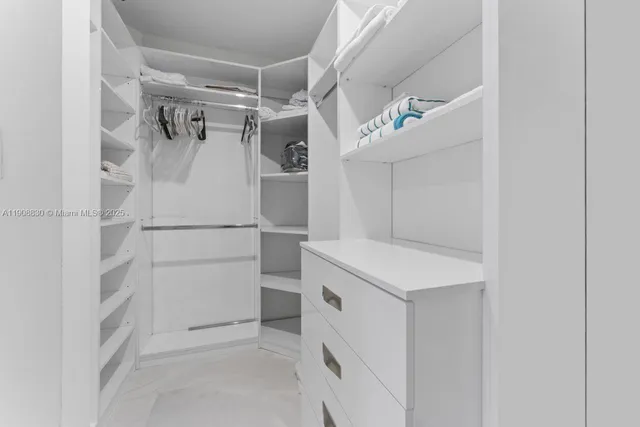 a bathroom with a granite countertop sink a toilet a mirror and shower