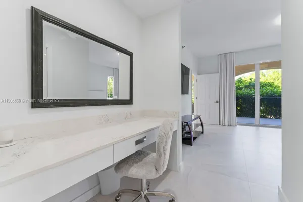 a bathroom with a tub sink and mirror