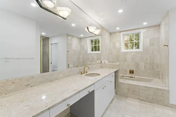 a bathroom with a granite countertop toilet sink and shower