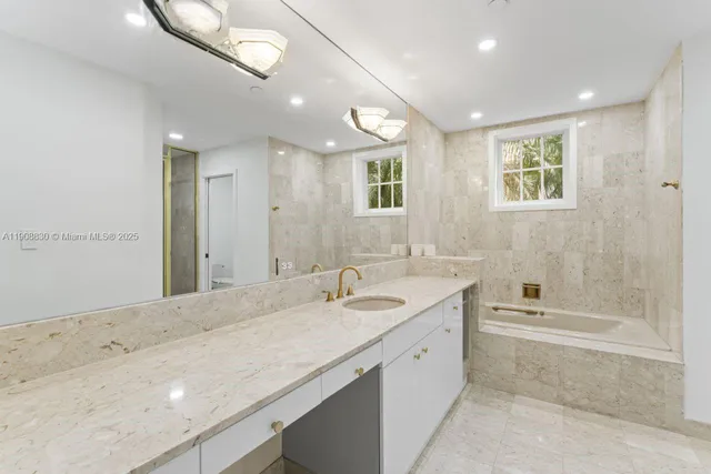 a bathroom with a granite countertop toilet sink and shower