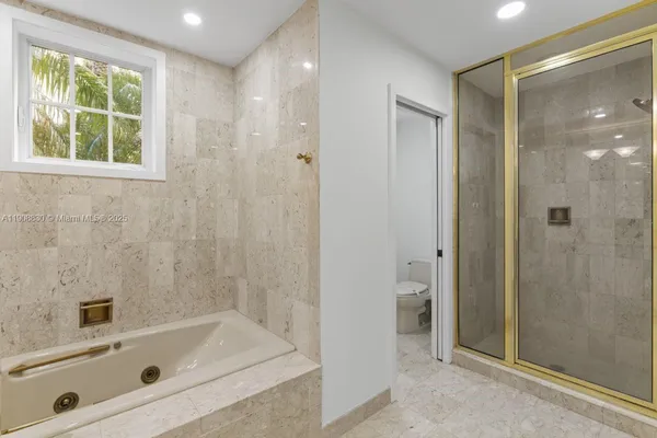 a spacious bathroom with a shower toilet and sink