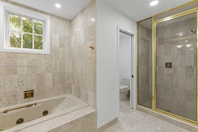 a spacious bathroom with a shower toilet and sink