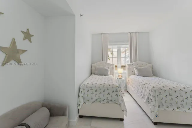 a living room with patio furniture and a floor to ceiling window