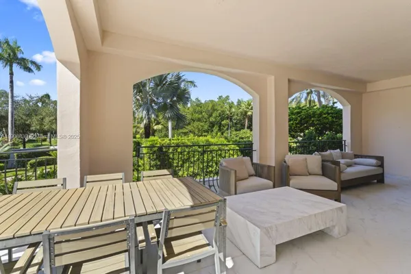 a view of a patio with a table and chairs