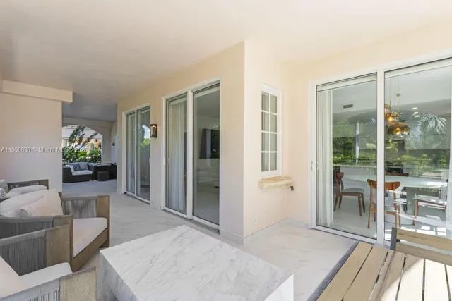 a view of a patio with table and chairs with wooden floor and fence