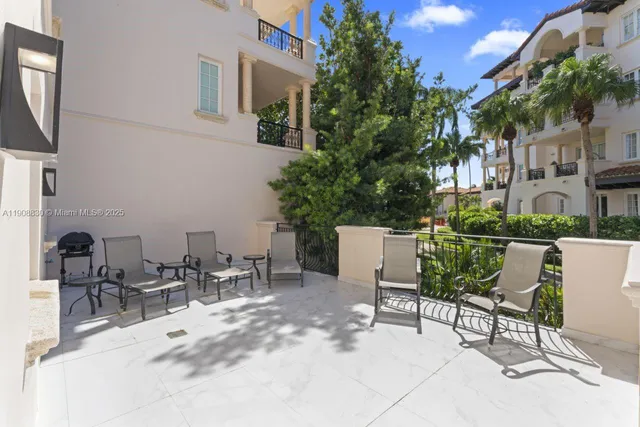 a view of a patio with table and chairs with wooden floor and fence