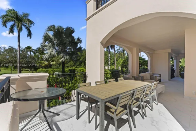 a view of a patio with table and chairs and potted plants