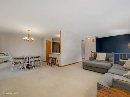 a living room with furniture and a dining table