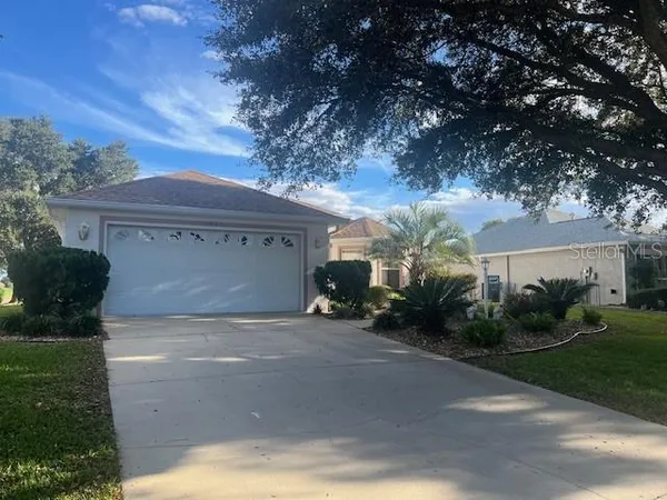 a view of a house with a yard and garage