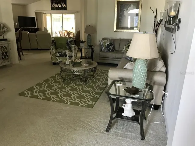 a living room with furniture and a lamp