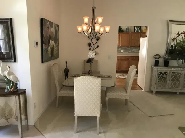 a living room with furniture a chandelier and a flat screen tv