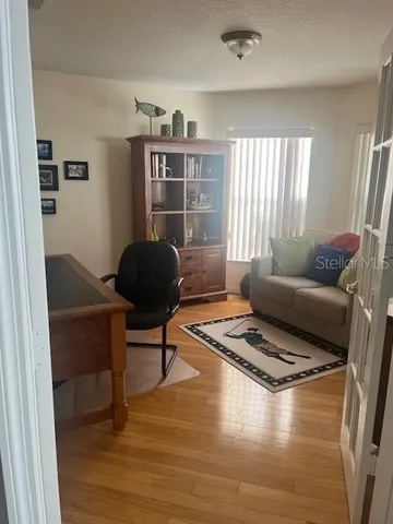 a living room with furniture and a book shelf