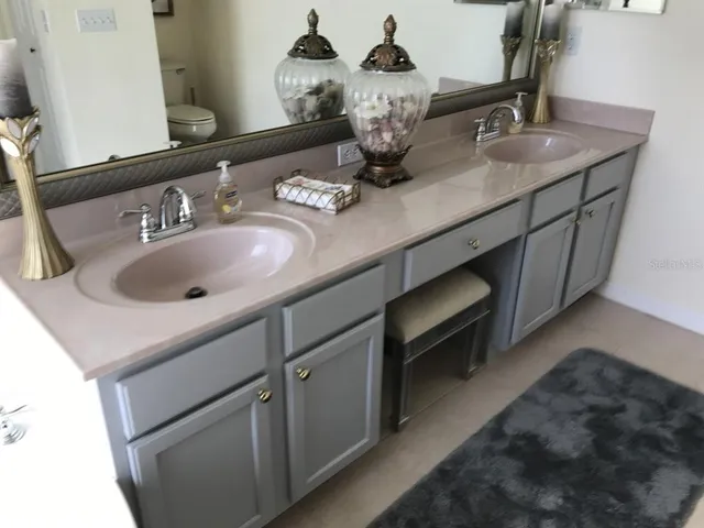 a bathroom with a double vanity sink and a mirror