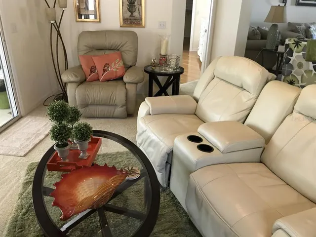 a living room with furniture and a mirror
