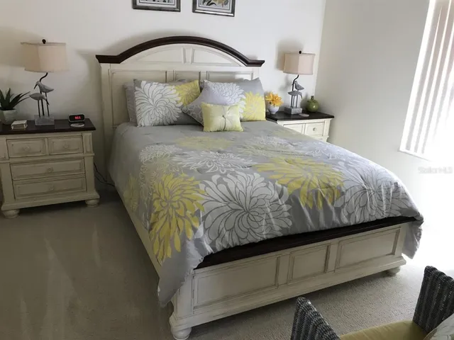 a bed sitting in a bedroom next to a window