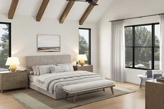 a bedroom with a bed a window and painting on the wall