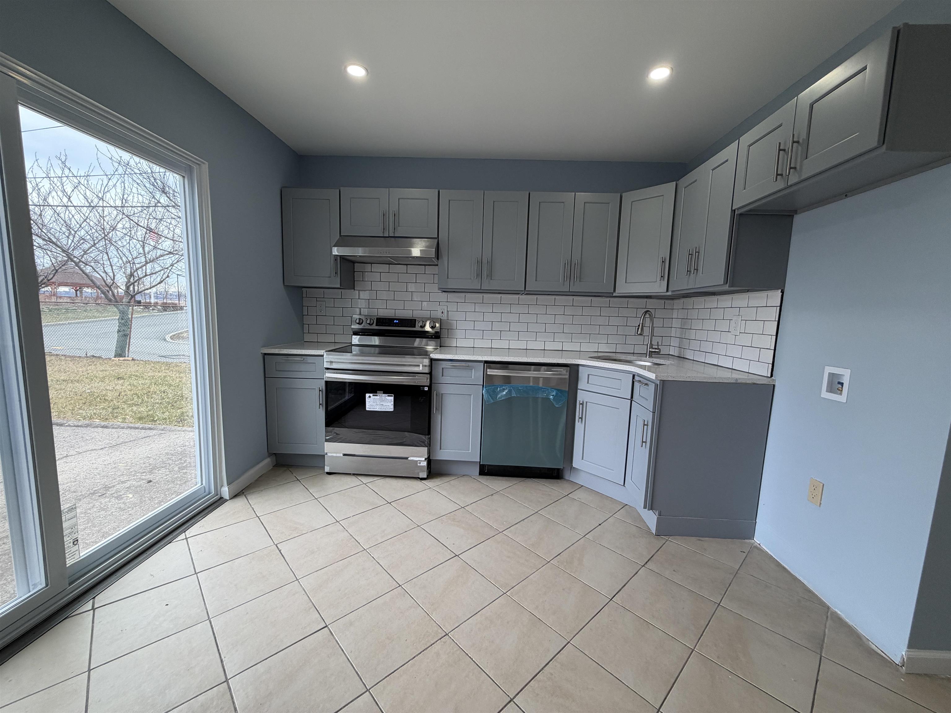 14 Acorn Road, Unit 1 Secaucus, NJ 07094 - Photo 2 of 14 a kitchen with stainless steel appliances granite countertop a stove a sink and a refrigerator