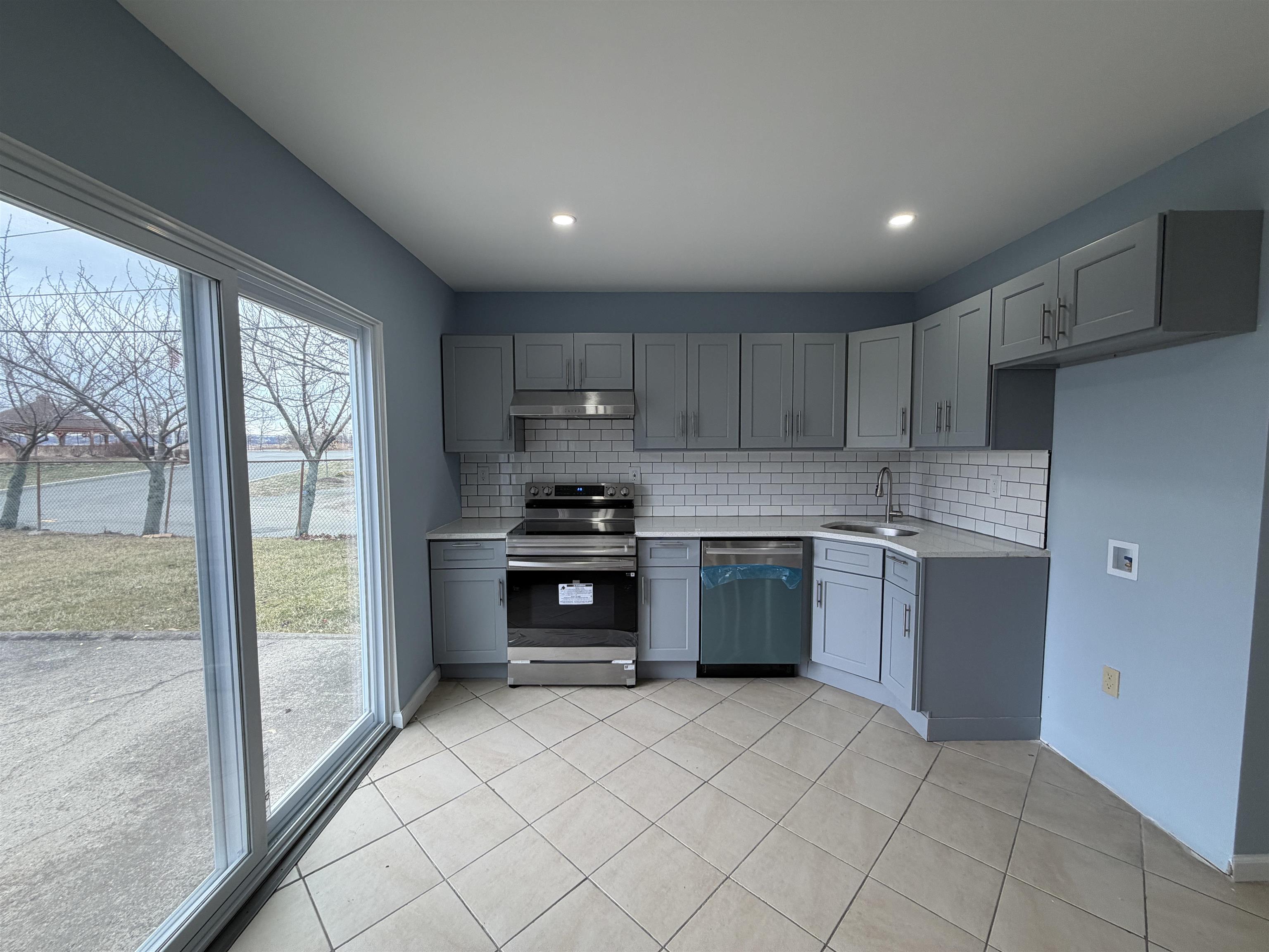14 Acorn Road, Unit 1 Secaucus, NJ 07094 - Photo 4 of 14 a kitchen with a refrigerator sink and cabinets