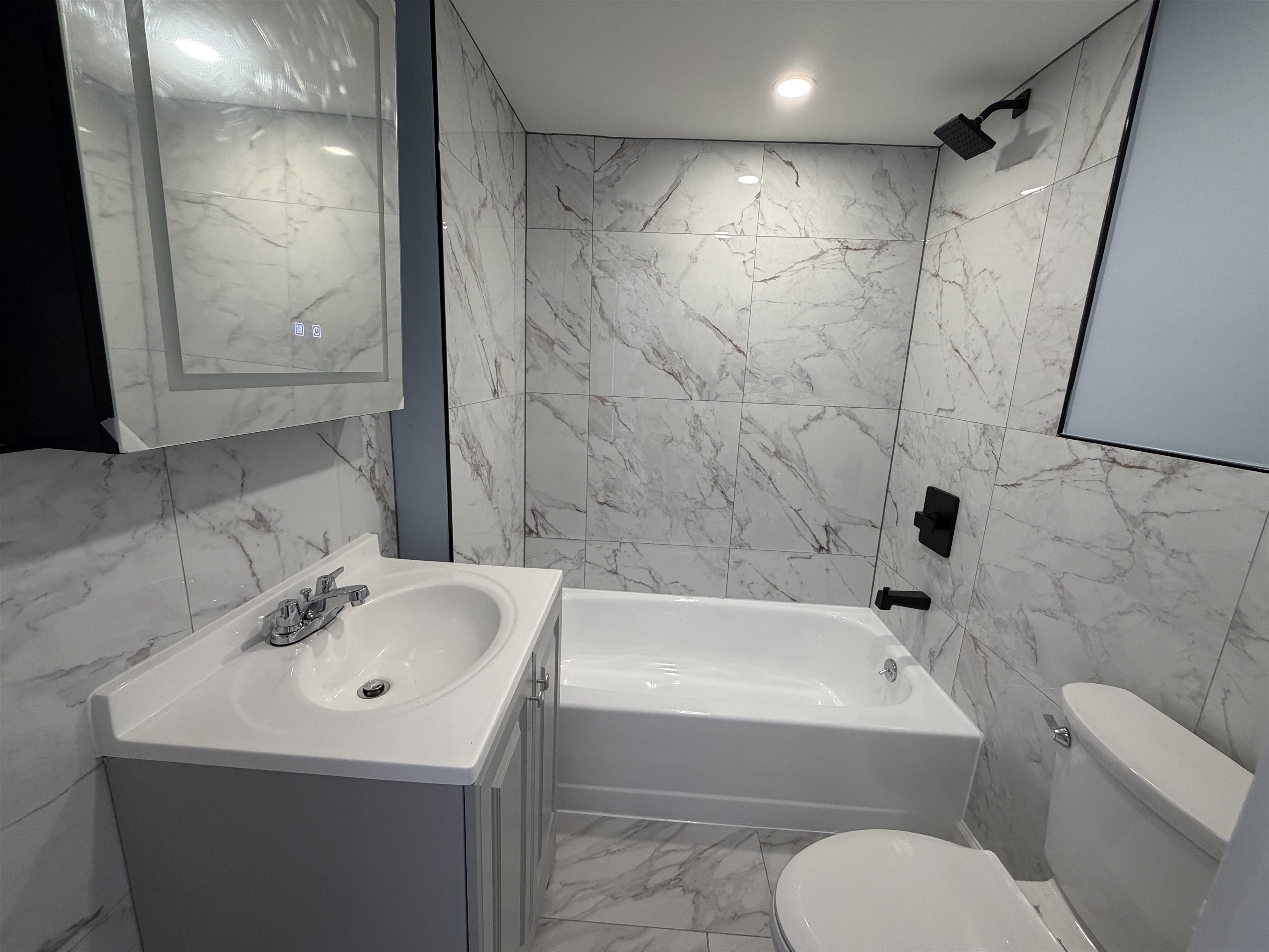 14 Acorn Road, Unit 1 Secaucus, NJ 07094 - Photo 6 of 14 a bathroom with a sink a toilet and shower