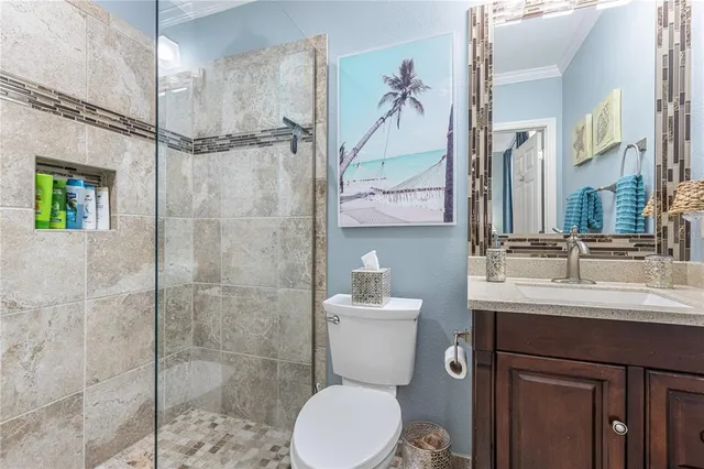 a bathroom with a toilet a sink and shower