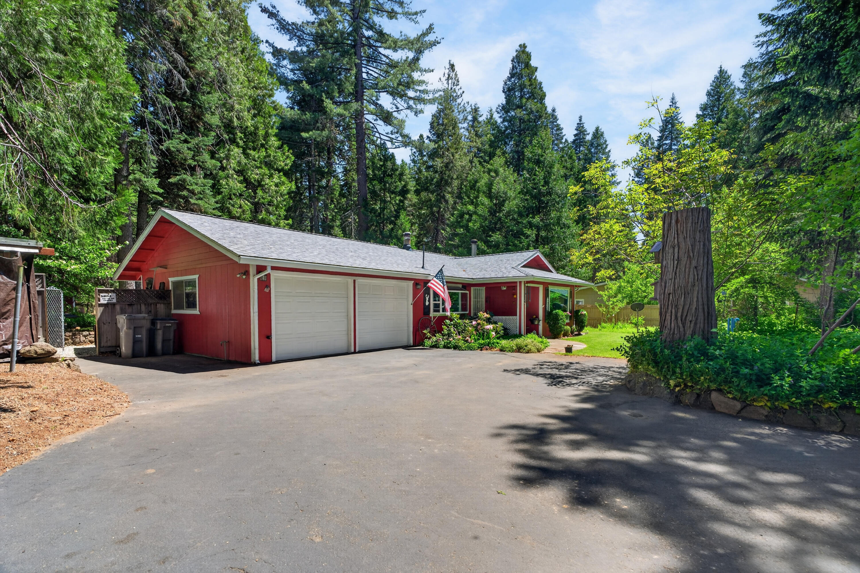 8015 Starlite Pines Road Shingletown, CA 96088 - Photo 1 of 38 a front view of a house with a yard and trees