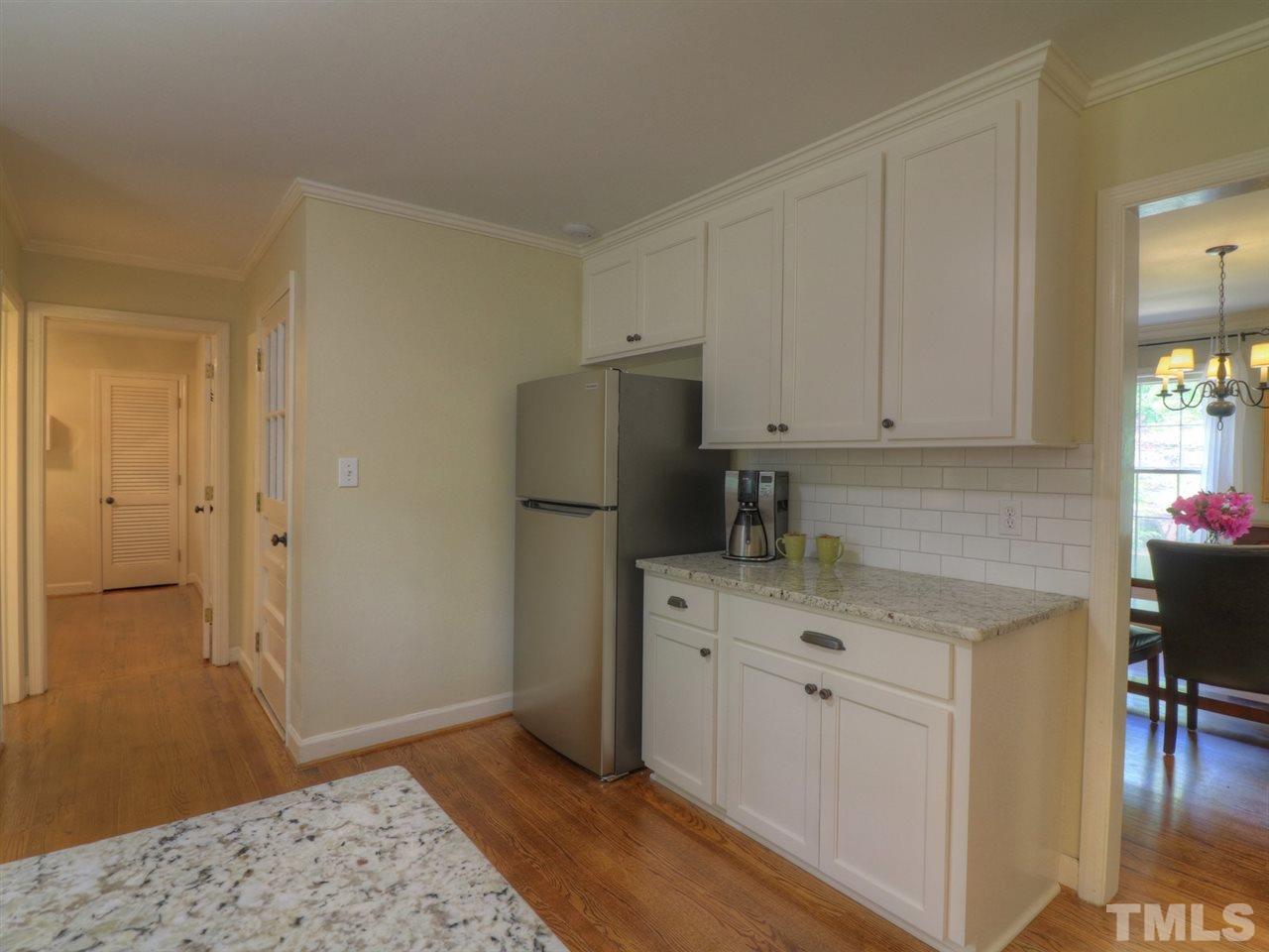 704 Compton Road Raleigh, NC 27609 - Photo 14 of 30 a kitchen with a refrigerator and cabinets