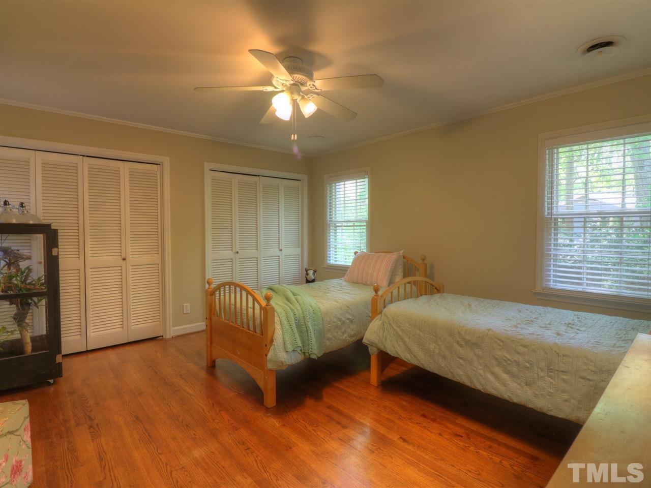 704 Compton Road Raleigh, NC 27609 - Photo 22 of 30 a bedroom with two beds and a chandelier