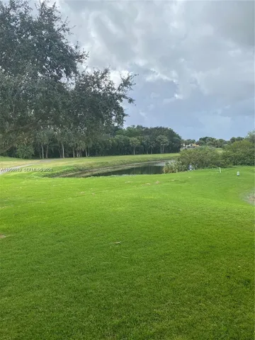 a view of a green field with clear sky