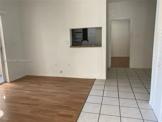 a view of a livingroom with an empty space and a fireplace