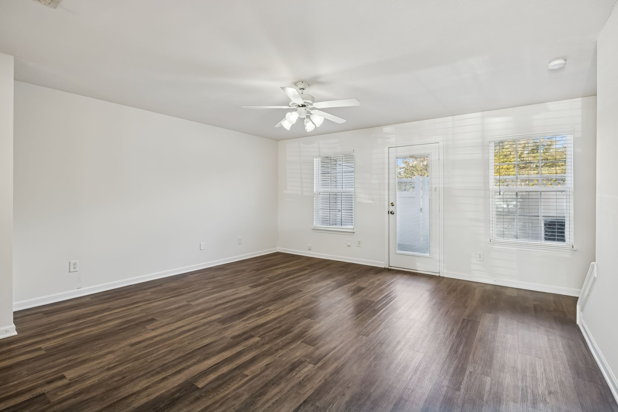 1791 Red Jacket Drive Antioch, TN 37013 - Photo 10 of 48 an empty room with wooden floor chandelier fan and windows