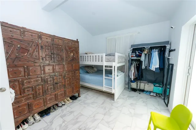 a view of a backyard with plants and a bench