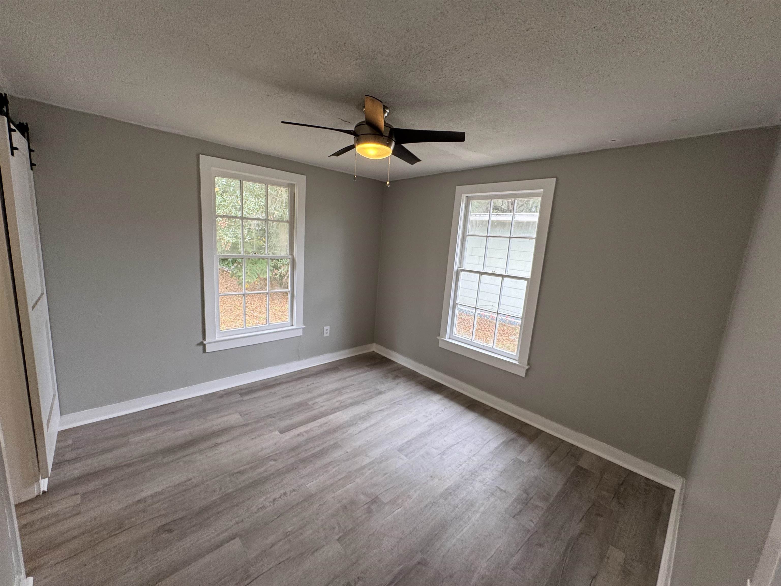 2909 Lane Street Palatka, FL 32177 - Photo 14 of 21 a view of an empty room with window and wooden floor