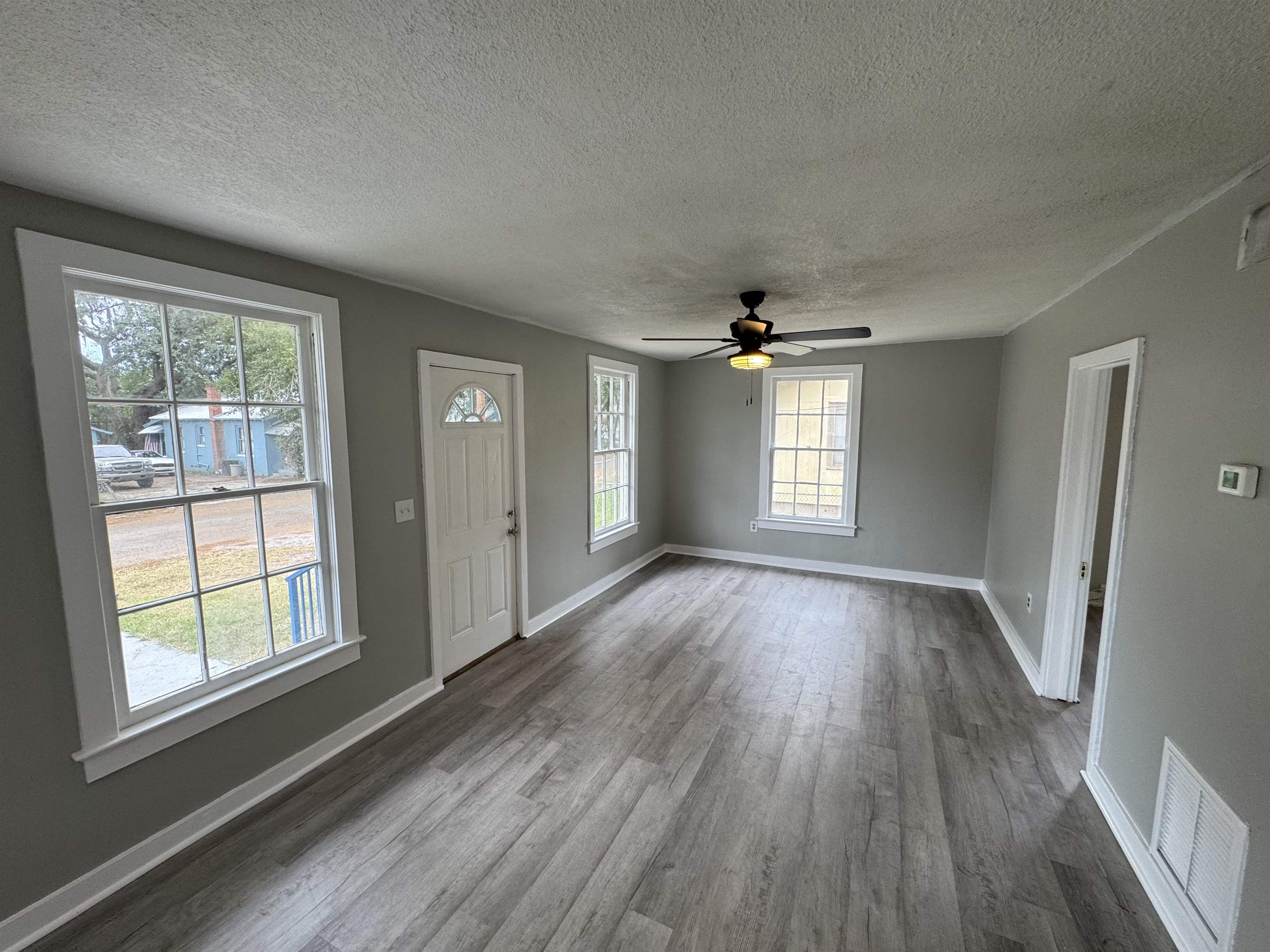 2909 Lane Street Palatka, FL 32177 - Photo 3 of 21 an empty room with wooden floor and windows