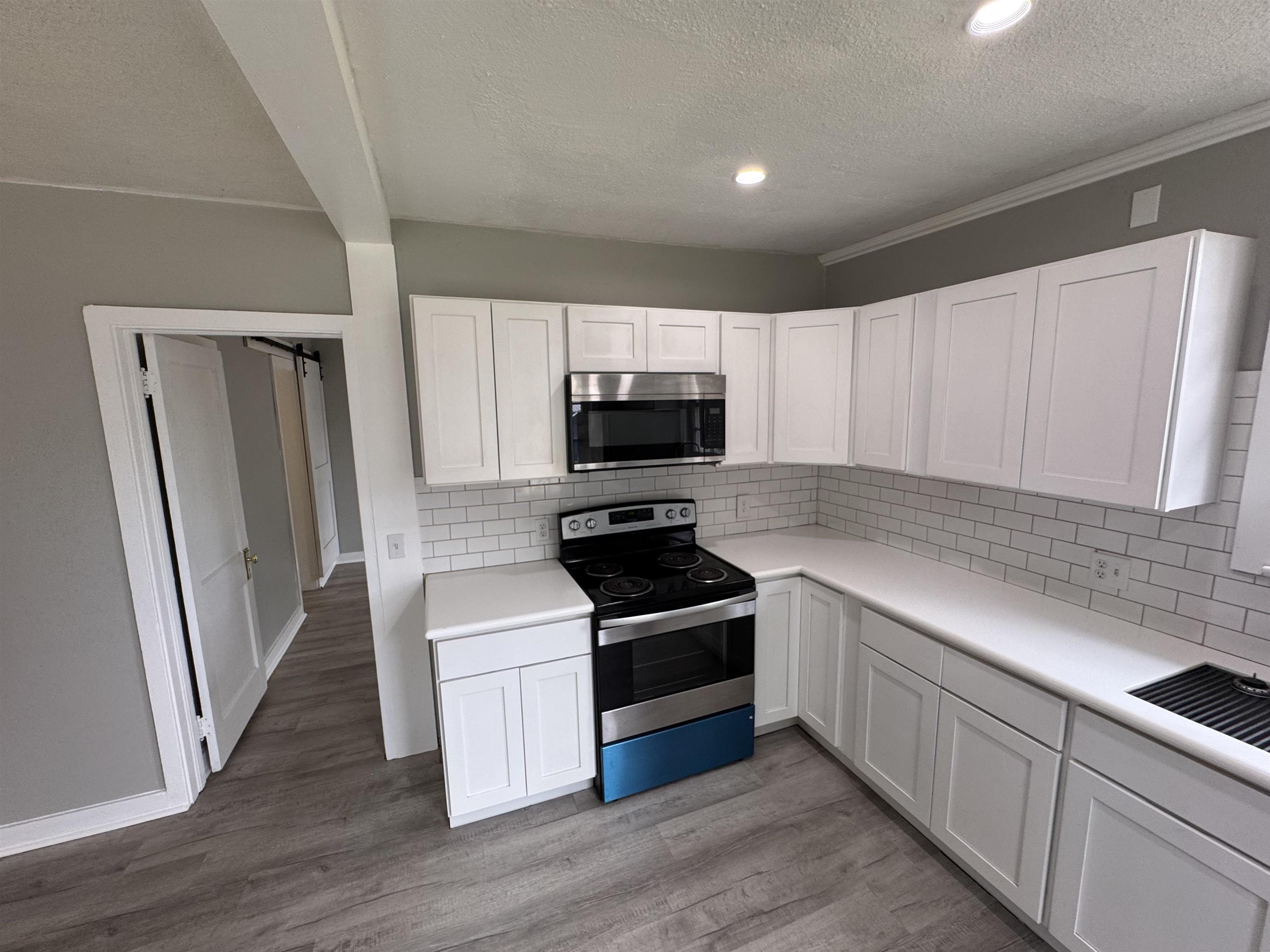 2909 Lane Street Palatka, FL 32177 - Photo 7 of 21 a kitchen with granite countertop a sink and steel appliances