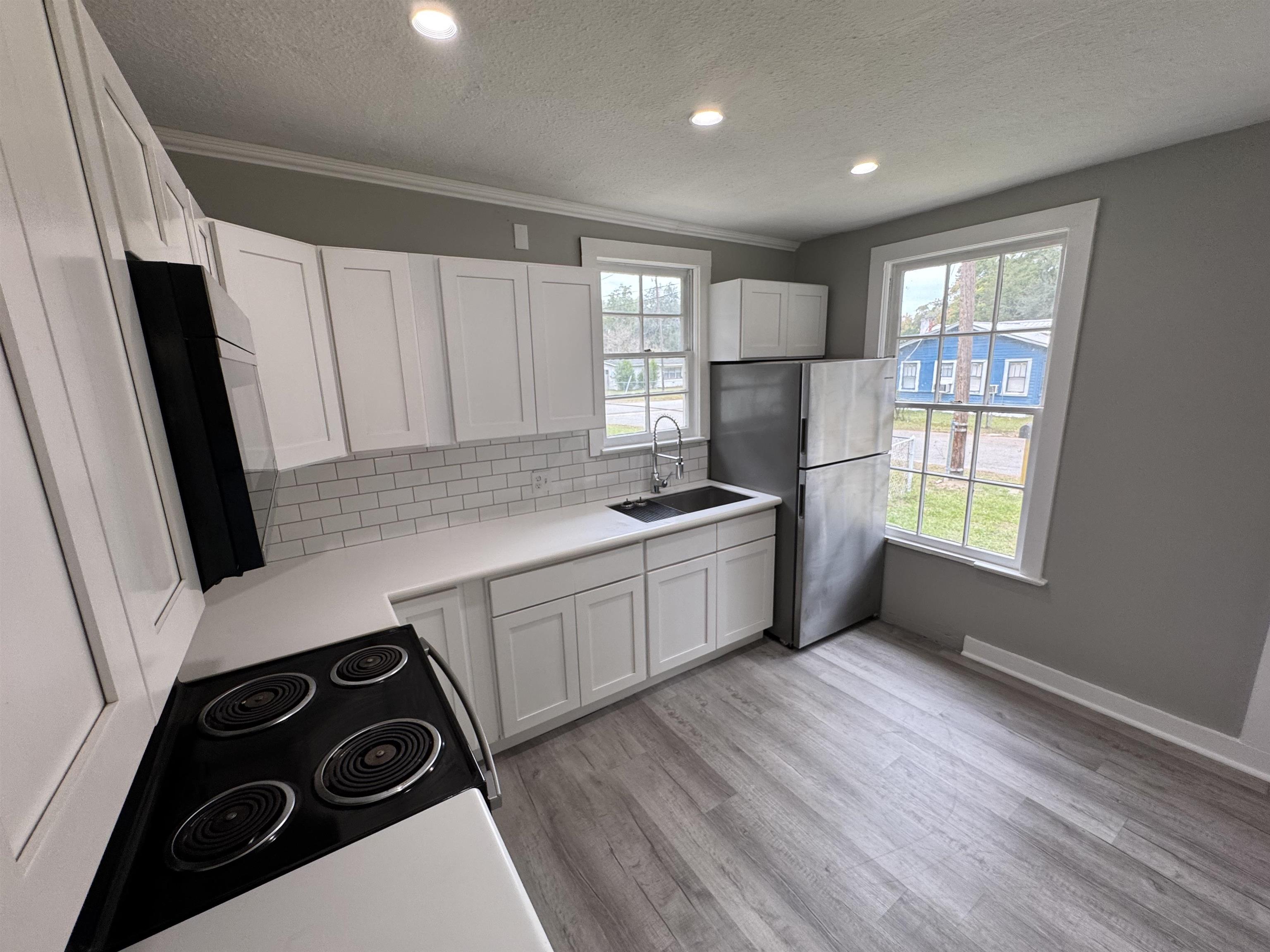 2909 Lane Street Palatka, FL 32177 - Photo 8 of 21 a kitchen with a refrigerator a sink and wooden floor
