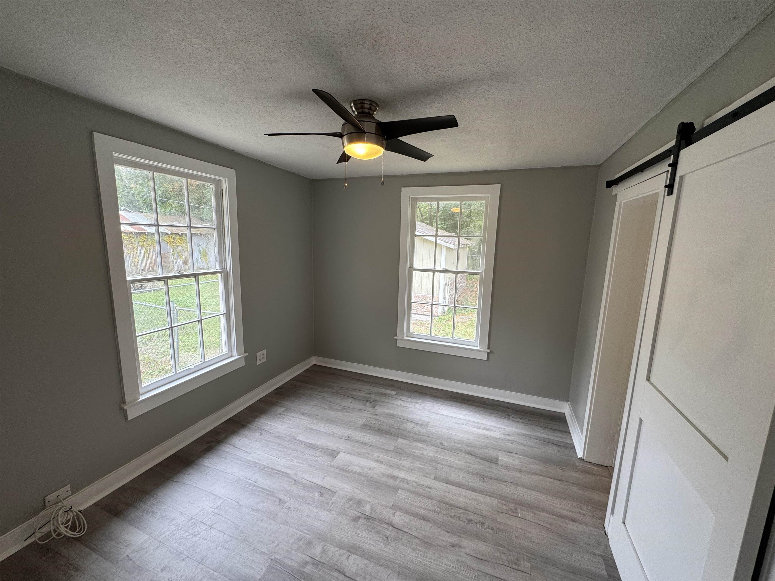 2909 Lane Street Palatka, FL 32177 - Photo 9 of 21 a view of an empty room with a window and wooden floor
