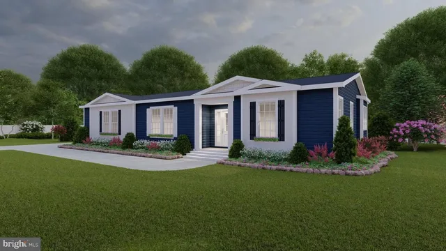 a front view of a house with a garden and yard