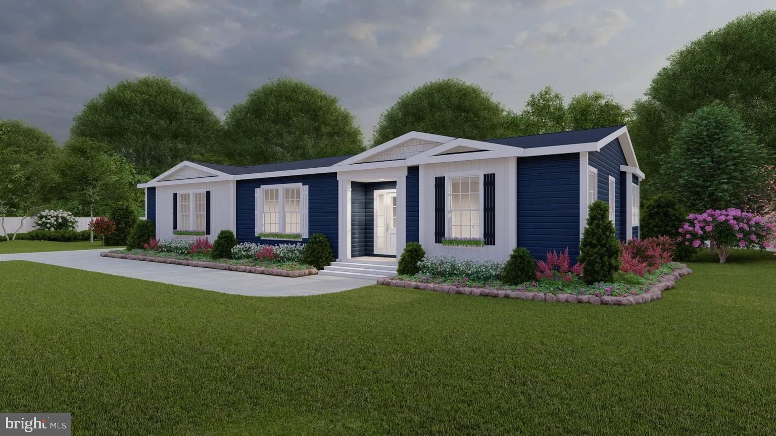 a front view of a house with a garden and yard