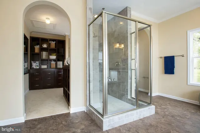 a bathroom with a glass shower door and a sink