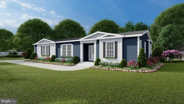 a front view of a house with a yard and potted plants