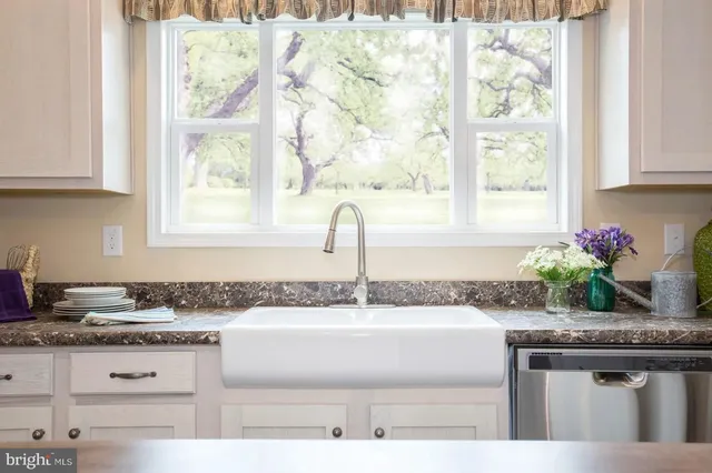 a kitchen with granite countertop a sink and a window