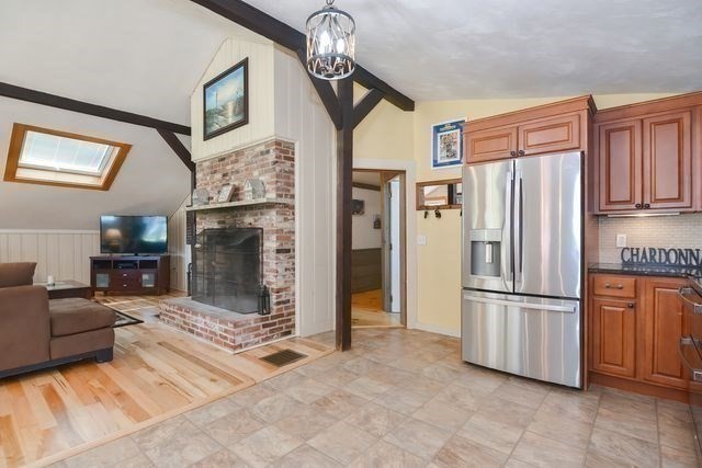 127 Haverhill Road Amesbury, MA 01913 - Photo 11 of 42 a kitchen with stainless steel appliances granite countertop a refrigerator a stove a microwave cabinets and a dining table
