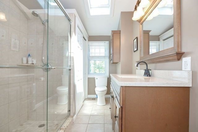 127 Haverhill Road Amesbury, MA 01913 - Photo 12 of 42 a en suite bathroom with a granite countertop sink toilet and shower
