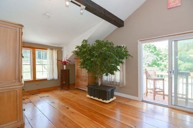 127 Haverhill Road Amesbury, MA 01913 - Photo 15 of 42 a view of an empty room with a window and wooden floor