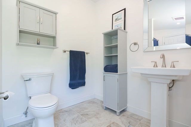127 Haverhill Road Amesbury, MA 01913 - Photo 16 of 42 a bathroom with a toilet sink and mirror