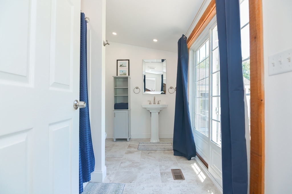 127 Haverhill Road Amesbury, MA 01913 - Photo 17 of 42 a view of a hallway with bathroom and a glass door